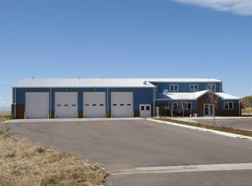 multibay metal building with blue wall panels and office area