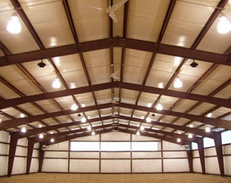 covered horse riding arena with lighting