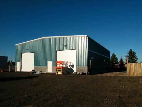 metal shop building with 2 bay doors and blue panels